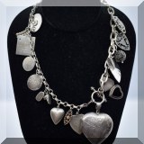 J059. Silver charms necklace. Most charms marked sterling. 24” - $85 